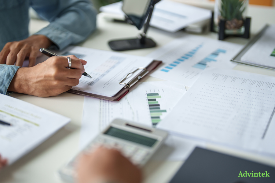 UAE e-Invoicing Guide: PEPPOL Framework, Requirements & Compliance Timeline (2026–2027) 1 Business professionals validating financial records for UAE Peppol E-invoicing compliance readiness