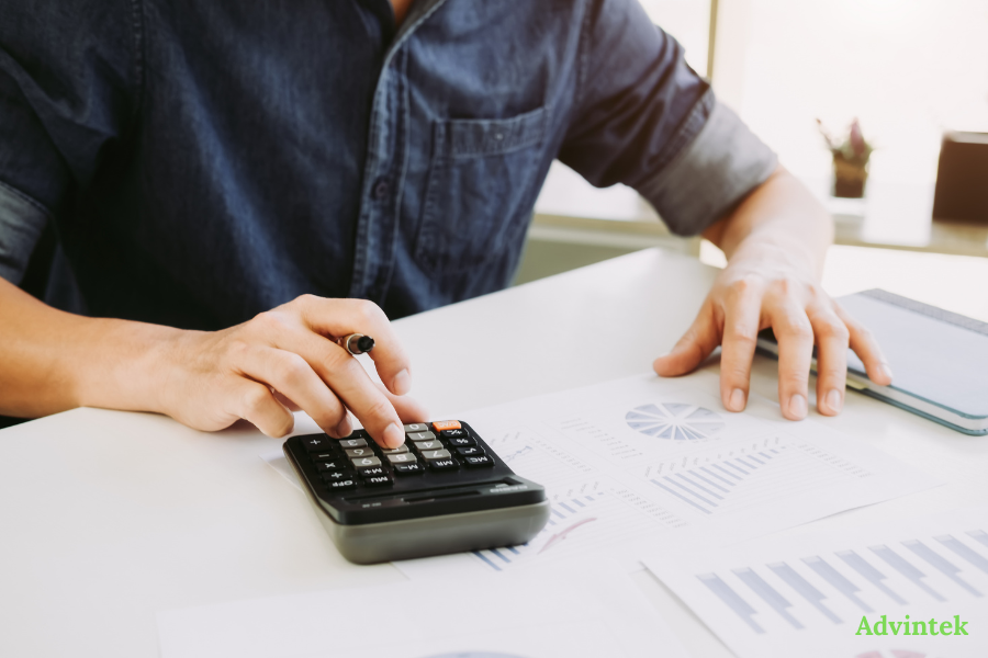 PINT AE Format Explained: The UAE’s Mandatory XML Invoice Standard 1 Finance professional reviewing reports with fta compliant invoicing software for PINT AE UAE e-invoicing compliance