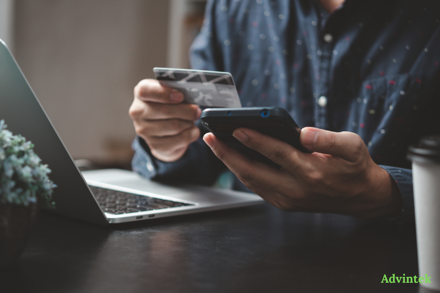 UAE E-Invoicing for Oracle: NetSuite, Oracle ERP Cloud, and JD Edwards Compared 3 Person using card and mobile phone for UAE e-invoicing and digital invoice payment