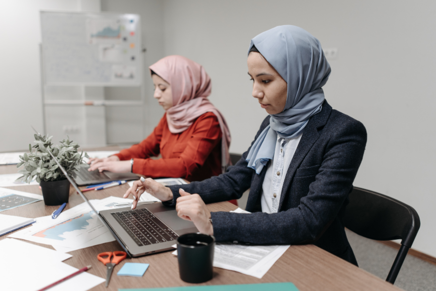 UAE e-Invoicing Guide 2026: Compliance, Timeline & Business Requirements 2 Two businesswomen working on laptops and reviewing financial reports in an office