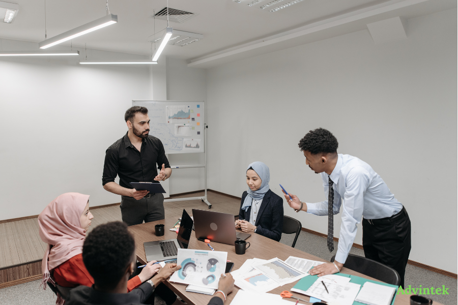 UAE E-Invoicing for QuickBooks and Zoho Books: Can Your Accounting Software Comply? 3 Business team reviewing financial reports and digital invoicing workflows for UAE e-invoicing compliance