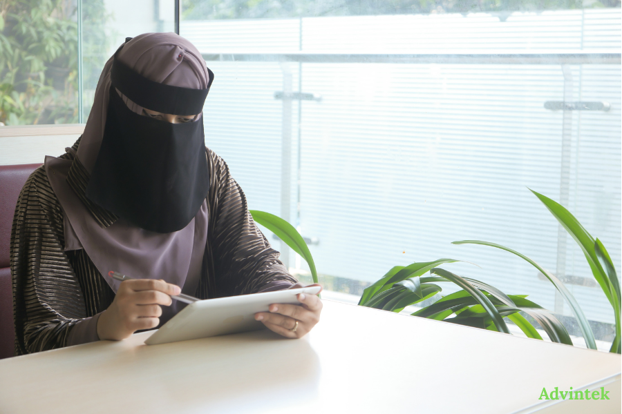 Woman reviewing digital documents on tablet for UAE e-invoicing compliance