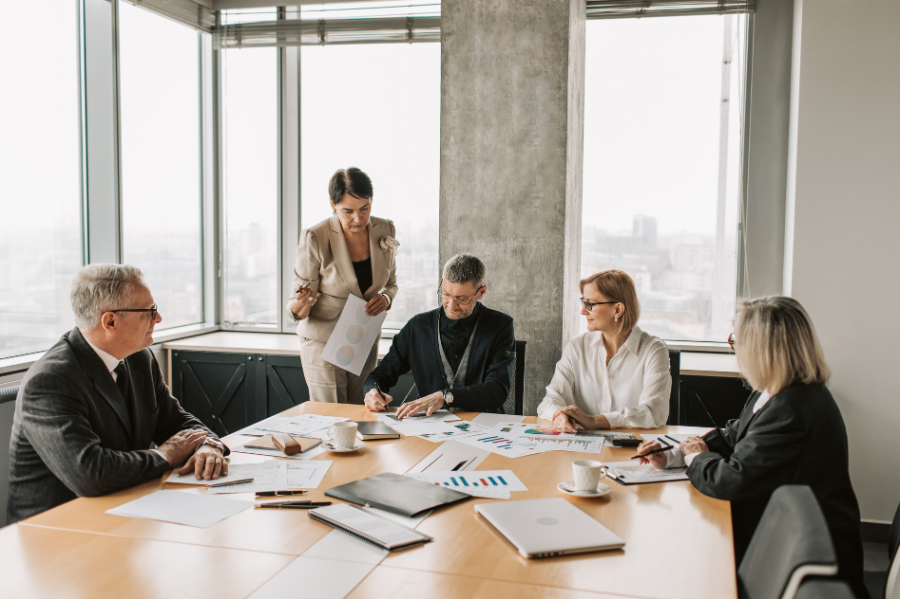 How Much Does E-Invoicing Actually Cost a Mid-Size UAE Business? A Real Breakdown 2 Business leadership team reviewing financial reports and performance data during a corporate strategy meeting