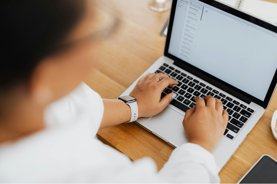 UAE E-Invoicing: Key Requirements, Implementation Timeline and Latest Updates 1 person UAE e-invoicing on laptop